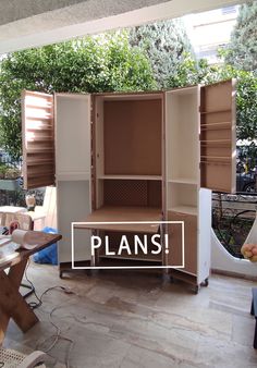 an open cabinet sitting on top of a hard wood floor