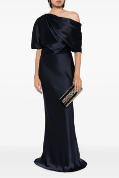 a woman in a long black dress with an off the shoulder top and clutch bag