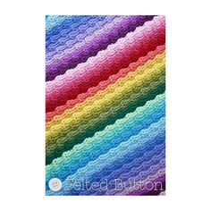 a multicolored crocheted blanket with wavy stripes