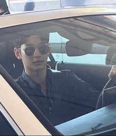 a man sitting in the driver's seat of a car