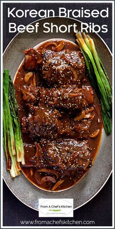 korean braised beef short ribs on a plate with asparagus