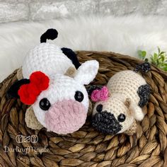 two crocheted stuffed animals sitting on top of a basket