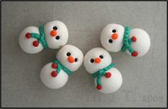 four snowmen with green and red bows on their heads are shown from the top down