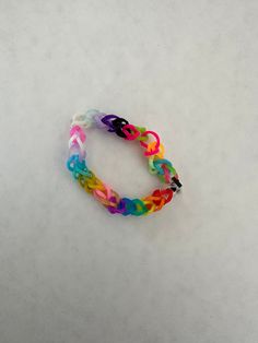 a multicolored bracelet on a white surface