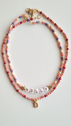 ❤️ PRODUCT DETAILS❤️ Adorn yourself in elegance with our customizable beaded necklace, featuring a vibrant mix of pink and purple beads complemented by intricate gold-plated bead details. Elevate your style or surprise a loved one with this personalized piece, designed to add a touch of sophistication to any outfit. Combination necklace in the photo:   https://www.etsy.com/listing/1539578875/custom-gold-initial-charm-necklace?click_key=9ca908a147b6ac2b551227783c627cbedee0759a%3A1539578875&click_sum=eb67b3b5&ref=shop_home_active_21&pro=1 ❤️ CARE ❤️ ❤️ Keep jewelry dry and avoid contact with water, lotions, etc ❤️ SIZE❤️ If you want a different length, write the size in the message to seller box when you check out.  Lenght: 15-16 inch/38-41 cm. ❤️ PACKAGING ❤️ ❤️ Each order comes with a love Beaded Initial Necklace, Purple Beaded Necklace With Letter Beads As Gift, Gold Beaded Necklaces With Letter And Round Beads, Gold Beaded Necklaces With Letter Beads, Pink Letter Beads For Jewelry Making, Personalized Pink Round Bead Necklaces, Personalized Pink Round Beads Necklace, Pink Letter Beads Necklace For Jewelry Making, Pink Necklace For Jewelry Making With Letter Beads