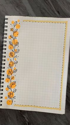 an open notebook with yellow flowers on it