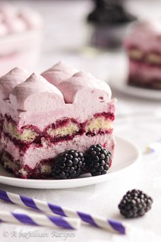 a piece of cake that is on a plate with berries and ice cream in it