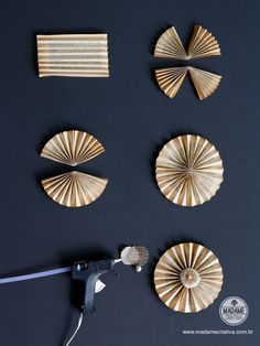 four wooden fan shaped objects sitting on top of a black table next to a blow dryer