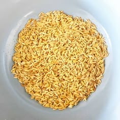 a white bowl filled with yellow rice on top of a table