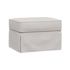 a white ottoman sitting on top of a floor