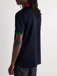 Gucci's polo shirt is a refined take on a preppy staple. It's made from stretch-cotton piqué and detailed with signature green and red stripes at the collar. The chest pocket is discreetly embroidered with the label's monogram. Large to size. See Size & Fit notes. Gucci Cotton Short Sleeve Polo Shirt, Gucci Cotton Polo Shirt, Gucci Casual Collared Polo Shirt, Casual Gucci Polo Shirt, Casual Gucci Collared Polo Shirt, Classic Gucci Cotton Polo Shirt, Casual Gucci Cotton Polo Shirt, Gucci Classic Cotton Polo Shirt, Luxury Blue Collared Polo Shirt