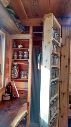 the inside of a tiny cabin with shelves and drawers