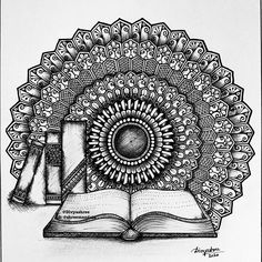 an open book sitting on top of a table next to a pen and ink drawing