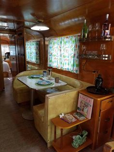 there is a table and chairs in the dining area on this train that has been converted into a living room