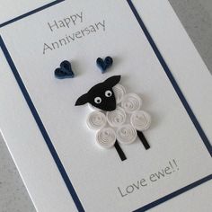 a happy anniversary card with a black sheep and two blue hearts on the front that says love ewe