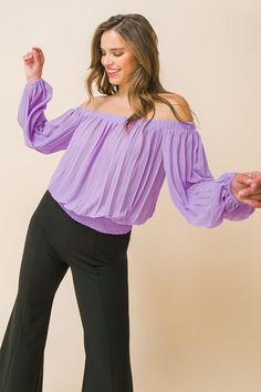 A solid woven top featuring accordion pleats, and elasticized off-the-shoulder neckline, long bishop sleeves, and a wide smocked waistband. Details Self: 100% polyester Size & Fit - Model is 5`8" and wearing size Small - Measurements taken from size Small - Length: 15" Trendy Evening Blouse In Solid Color, Chic Winter Blouse For Day Out, Chic Winter Blouse For Date Night, Chic Blouse For Date Night In Winter, Purple Tops For Night Out In Spring, Chic Purple Winter Tops, Purple Stretch Blouse For Party, Chic Fitted Purple Blouse, Fitted Purple Chic Blouse