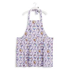 an apron with purple flowers on the front and back, hanging from a hanger