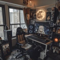 a home office with various computer equipment and pictures on the wall