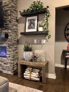 a living room filled with furniture and a fire place next to a wall mounted tv