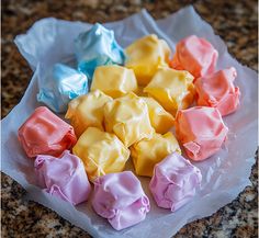 there are many different colored candies on the paper wrapper in the shape of hearts