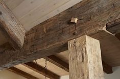 an old wooden beam with chains hanging from it's sides and wood beams on the ceiling