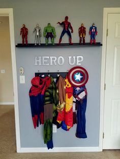 there is a shelf that has various toys on it and the words hero up above it