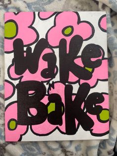 a pink and black sign that says wake bake