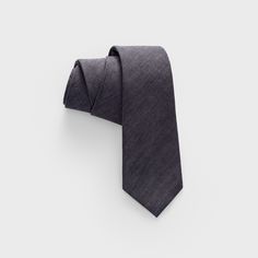 Our slim (but not skinny) gray tie is a classic staple for the well-dressed gentleman—perfect for any occasion. This beautiful piece is meticulously handcrafted with the finest fabric to give your look that extra touch of sophistication.  100% Cotton Cotton Ties For Black Tie Events In Summer, Cotton Ties For Black Tie Occasions In Summer, Classic Cotton Ties For Black Tie Occasions, Summer Cotton Ties For Business, Cotton Standard Tie For Summer, Casual Standard Tie For Workwear, Casual Suit And Tie Accessories For Workwear, Fitted Casual Cotton Ties, Casual Fitted Cotton Ties