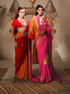 two women in colorful sari standing next to each other