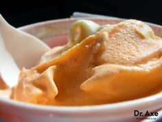 a close up of a bowl of food with spoons in it and sauce on the side