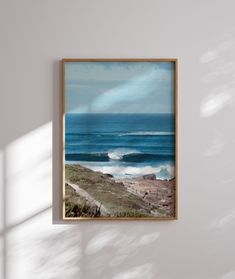 a painting hanging on the wall next to a window