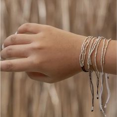 These Terra Layered Bracelets Feature Three Strands Of Dainty Silver Beads Attached To Delicately Woven Thread. Simple And Sophisticated. Lightweight And Adjustable For All Sizes. Available In Black, Grey, Terracotta, Desert Tan. Price Is For Each. Choose Color In Size Options. Details Made In Indonesia Weight: 2.4 Oz (68.04 G) Silver Friendship Bracelets With Silver Beads, Silver Resizable Beaded Bracelets For Festivals, Resizable Silver Beaded Bracelets For Festivals, Resizable Silver Beaded Bracelets, Silver Bracelets With Adjustable Length For Festivals, Adjustable Silver Beaded Bracelets For Party, Silver Bracelet With Adjustable Length For Festivals, Silver Bracelet With Tiny Beads For Festivals, Silver Tiny Beads Bracelet For Party