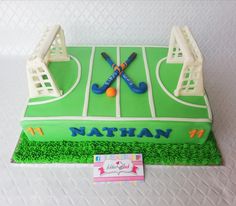 a cake that is decorated to look like a soccer field with two goalies on it