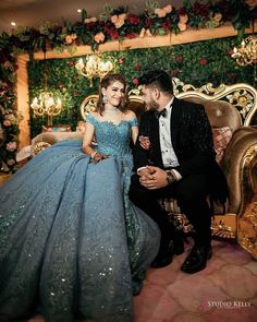 a man sitting next to a woman in a blue dress