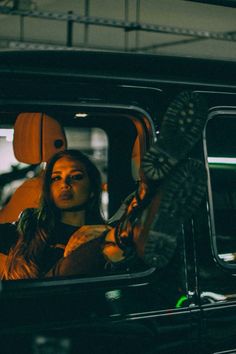 a woman sitting in the passenger seat of a car