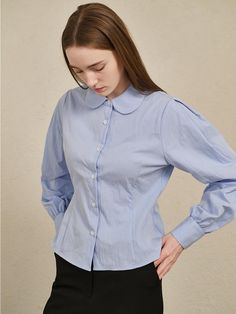 This round collar cotton shirt by Nouve combines a refined silhouette with sophistication, exuding modern mood.- Made with high-density bio-cotton fabric for a soft touch and minimal wrinkles- Features puff sleeves and a round collar for charming details- Slim waistline achieved with dart design* Threads and wrinkles that occur during the production process, as well as chalk marks, are not considered defects.* Actual product color may vary according to the monitor resolution. Classic Shirt With Puff Sleeves In Relaxed Fit, Classic Puff Sleeve Shirt With Relaxed Fit, Elegant Shirt With Puff Sleeves And Relaxed Fit, Blue Puff Sleeve Shirt For Work, Cotton Shirt With Relaxed Fit For Office, Cotton Relaxed Fit Shirt For Office, Cotton Puff Sleeve Shirt For Work, Relaxed Fit Cotton Shirt For Office, Cotton Puff Sleeve Shirt For Office