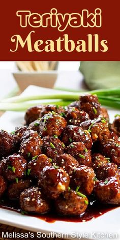 the meatballs are covered in sauce and garnished with scallions on a white plate