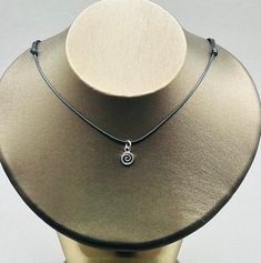 Discover our enchanting collection of necklaces designed to add a touch of elegance and mystery to your style. Our spiral or swirl necklace offers a unique and charming design, perfect for making a statement. Vortex Choker - Swirl choker will add a dynamic and vibrant look to your look. A black cord necklace is a versatile and stylish choice. It goes perfectly with any outfit. The Silver Wave design adds a touch of sophistication and elegance. Stay protected with our talisman necklace and protec Affordable Silver Spiral Necklace, Elegant Swirl Necklace For Gifts, Elegant Swirl Necklace For Gift, Elegant Adjustable Swirl Necklace, Spiral Adjustable Necklace As Gift, Adjustable Spiral Necklace As Gift, Adjustable Spiral Necklace For Gifts, Adjustable Spiral Necklace For Gift, Adjustable Swirl Jewelry For Gifts