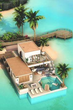 an aerial view of a house on the water with palm trees in the foreground