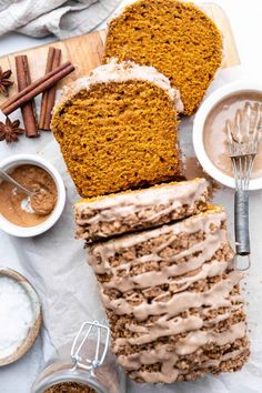 sliced loaf of pumpkin spice bread on a cutting board with cinnamon and spices around it