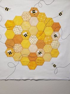 a piece of art that has been made to look like hexagons and bees