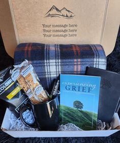 the gift box is filled with books, snacks and coffees for someone to enjoy