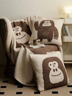 a brown and white blanket sitting on top of a chair next to a book shelf