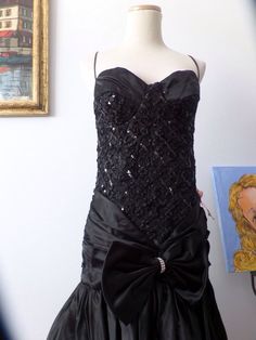 This dress rocks a bustier style top, with tight fitted bodice, handkerchief ham with lots of crinoline in the back to create fullness. Steampunk, rocker, retro glam...fabulous! Size 6 Black Corset For Prom Party, Black Corset For Prom Season Party, Black Corset For Party And Prom Season, Glamorous Fitted Corset For Prom, Glamorous Fitted Corset For Prom Season, Fitted Glamorous Corset For Prom Season, Strapless Fitted Corset Dress For Costumes, Overbust Corset For Prom Season Party, Party Corset With Ruffles And Fitted Bodice