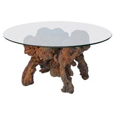 a glass table topped with wood pieces and a round glass top on an isolated white background