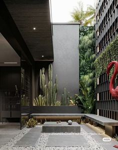 an outdoor courtyard with plants, rocks and benches