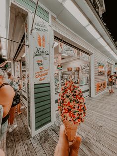 an ice cream cone with orange and green sprinkles sitting on top of it