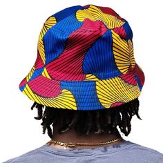 A unisex bucket cap made using authentic Ankara fabric. 58cm. Ankara, also known as African wax print or Dutch wax print, is a fabric characterized by vibrant patterns and colors. The fabric is made through a wax-resist dyeing technique called batik which creates distinct and colorful patterns. Ankara fabric is used to make a wide range of clothing and accessories, including dresses, skirts, shirts, and hats. Each pattern carries cultural meanings and stories making pieces made from this fabric not just fashion items but also carriers of African heritage and identity. Multicolor 5-panel Summer Hats, Multicolor 5-panel Hat For Streetwear, Multicolor Bucket Hat For Summer Streetwear, Casual Multicolor Bucket Hat For Streetwear, Multicolor Cotton Hat For Streetwear, Casual Multicolor Cotton Bucket Hat, Multicolor Reversible Cotton Sun Hat, Reversible Multicolor Cotton Sun Hat, Multicolor Reversible Cotton Bucket Hat