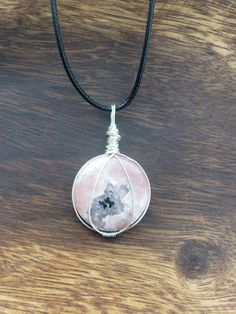 Wire-wrapped rhodochrosite pendant with a complimentary black cord. Rhodochrosite is stone of love that promotes emotional healing. Rhodochrosite Crystal Necklace, Valentines Presents, Emotional Healing, Wrapped Pendant, Star Necklace, Flower Necklace, Stone Pendants, Beautiful Necklaces, Washer Necklace