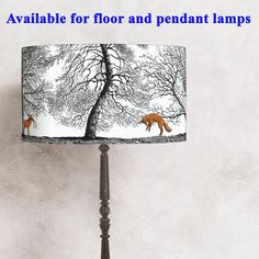 a lamp shade with an image of a fox in the woods on it's side